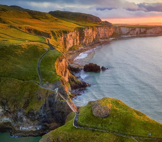 Dramatic cliffs in Ireland overlooking the Atlantic Ocean at sunset.