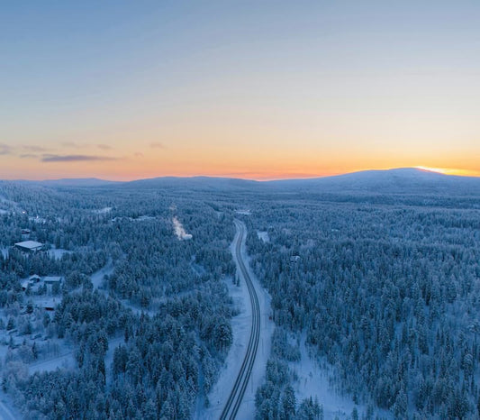 Sunset over a winter forest in Finland